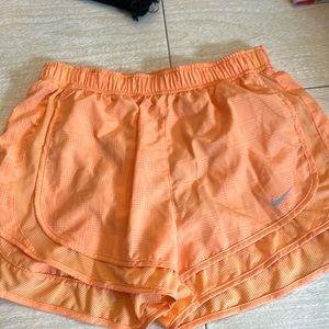 Orange Nike athletic shorts